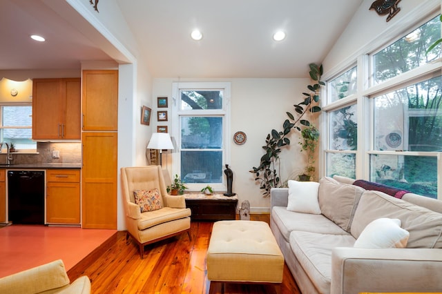 living room with light wood-type flooring, plenty of natural light, and recessed lighting