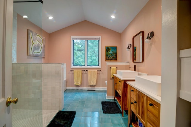 full bathroom with walk in shower, tile patterned floors, two vanities, lofted ceiling, and baseboards