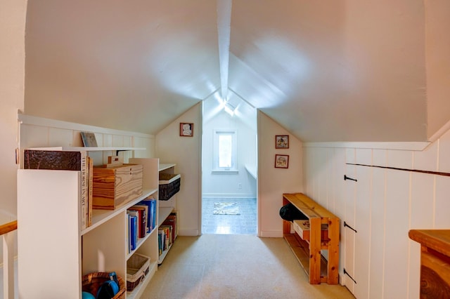 bonus room featuring light carpet and vaulted ceiling