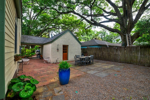 view of patio featuring fence and outdoor dining area