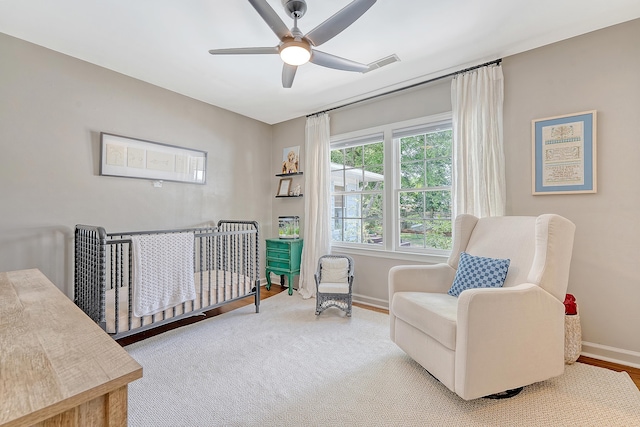 803 Burnett Dr, Charleston, SC 29412 - bedroom with baseboards, a crib, a ceiling fan, and wood finished floors