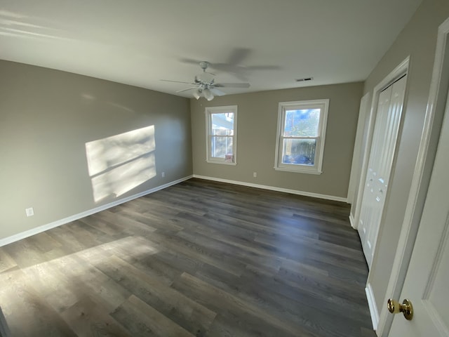 unfurnished bedroom with dark wood-type flooring and ceiling fan