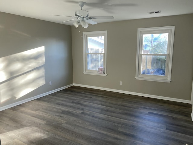 empty room with dark wood-type flooring and ceiling fan