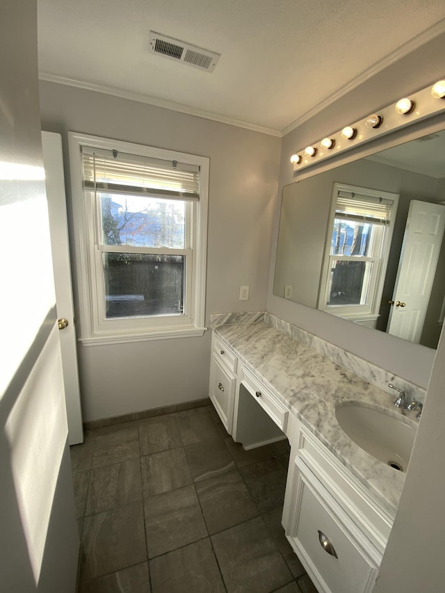 bathroom with crown molding, tile patterned floors, and vanity