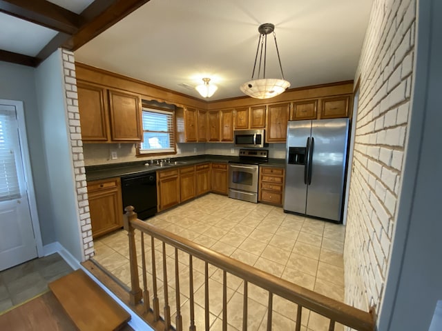 kitchen featuring sink, light tile patterned flooring, pendant lighting, and appliances with stainless steel finishes