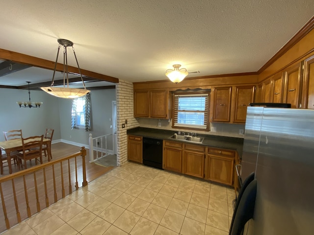 kitchen featuring a wealth of natural light, black dishwasher, stainless steel refrigerator, sink, and decorative light fixtures