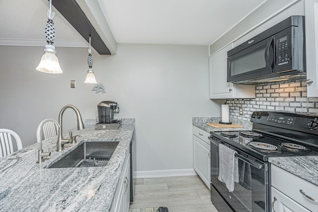 kitchen with white cabinets, sink, black appliances, and pendant lighting