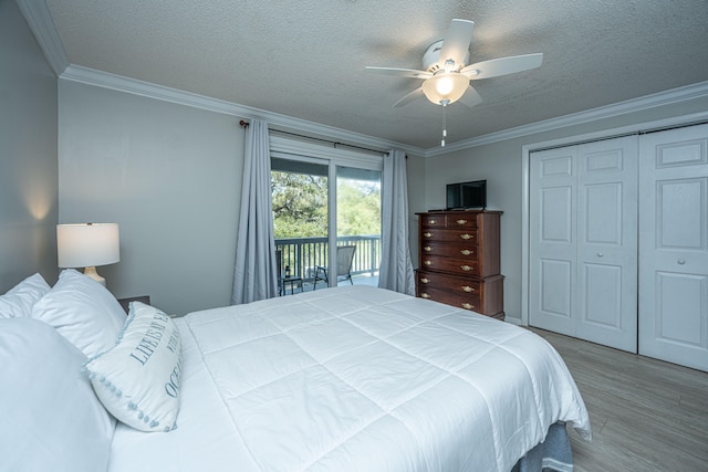 bedroom with ceiling fan, a closet, a textured ceiling, access to outside, and ornamental molding