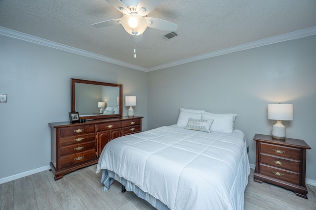 bedroom featuring crown molding, a textured ceiling, ceiling fan, and light wood-type flooring