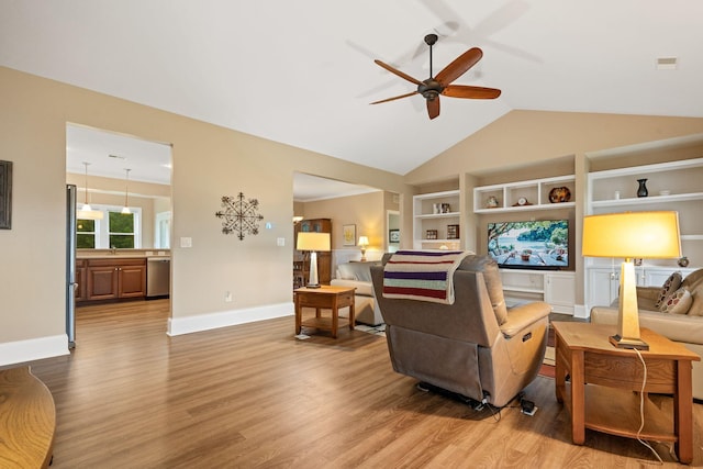 727 Sonny Boy Ln, Johns Island, SC 29455 - living area featuring a ceiling fan, light wood-type flooring, baseboards, vaulted ceiling, and built in shelves