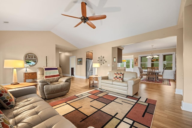 727 Sonny Boy Ln, Johns Island, SC 29455 - living room with light wood-style flooring, ceiling fan, a chandelier, lofted ceiling, and baseboards