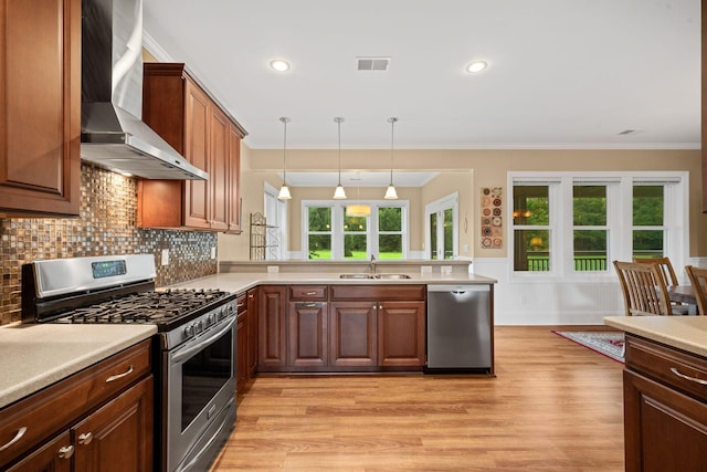 727 Sonny Boy Ln, Johns Island, SC 29455 - kitchen with stainless steel appliances, wall chimney range hood, a sink, ornamental molding, and light countertops