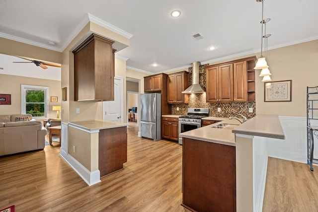 727 Sonny Boy Ln, Johns Island, SC 29455 - kitchen featuring stainless steel appliances, a peninsula, a sink, wall chimney exhaust hood, and decorative backsplash
