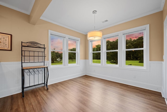727 Sonny Boy Ln, Johns Island, SC 29455 - unfurnished dining area featuring wood finished floors, wainscoting, and crown molding