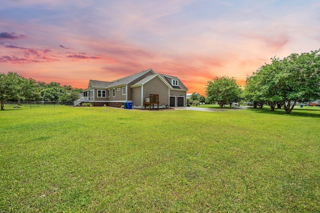 727 Sonny Boy Ln, Johns Island, SC 29455 - back of house at dusk featuring an attached garage and driveway