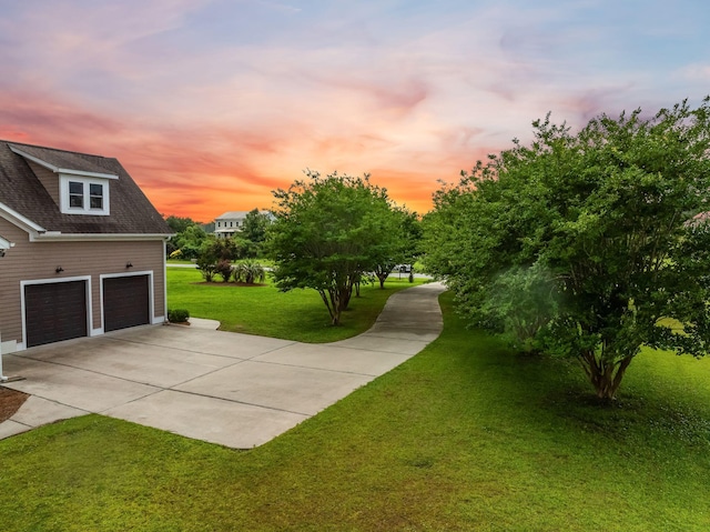 727 Sonny Boy Ln, Johns Island, SC 29455 - yard at dusk featuring driveway, a garage, and a yard