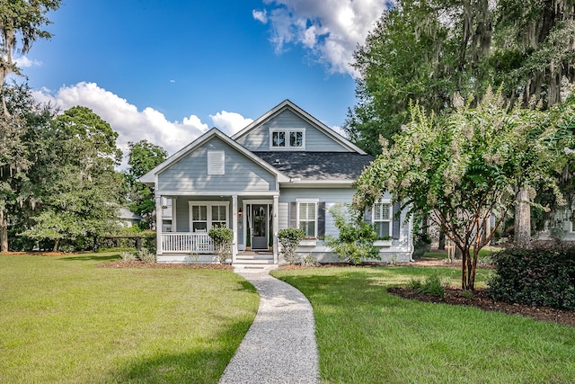 view of front of home with covered porch and a front lawn