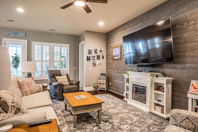 living room featuring wood-type flooring and ceiling fan