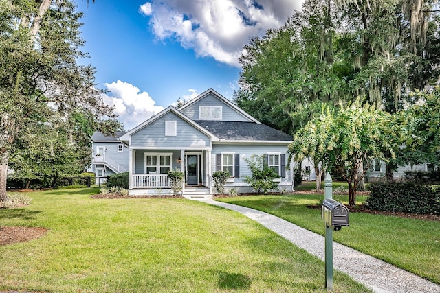15 Carter Oaks, Ladys Island, SC 29907 - bungalow-style house featuring a porch, a front lawn, and roof with shingles