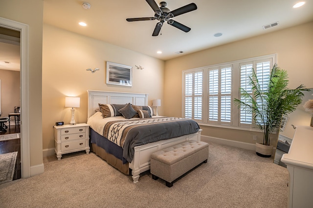 bedroom featuring light carpet and ceiling fan