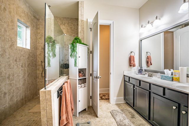 bathroom with vanity, tile patterned floors, and tiled shower