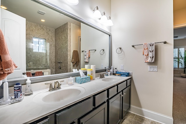 bathroom with vanity, tile patterned floors, and tiled shower