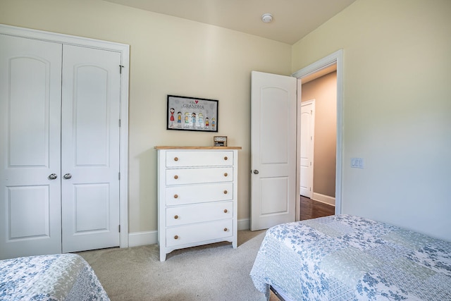 bedroom with light carpet and a closet