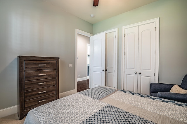 bedroom with a closet, ceiling fan, and carpet flooring