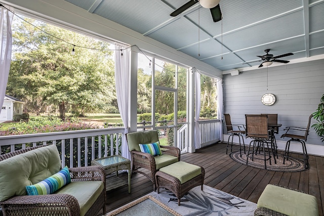 sunroom featuring ceiling fan