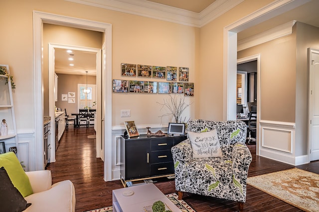 sitting room with dark wood-type flooring and ornamental molding