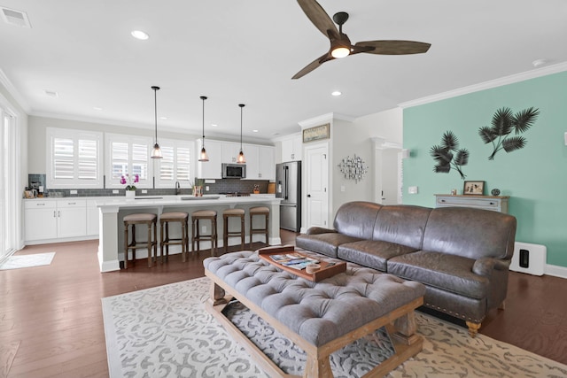 living room featuring ornamental molding, dark hardwood / wood-style floors, and ceiling fan