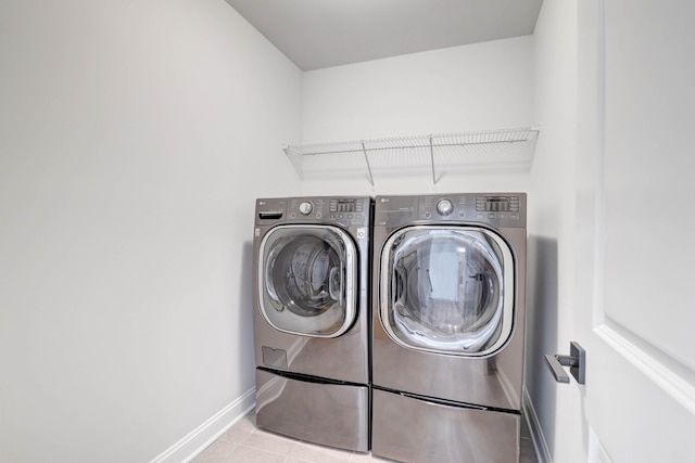 washroom featuring light tile patterned floors and washer and dryer