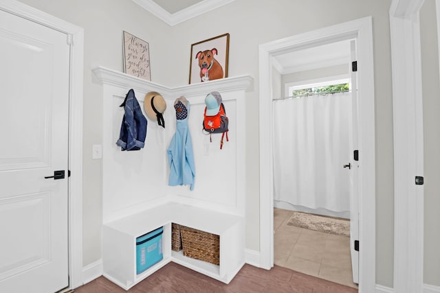 mudroom featuring crown molding and tile patterned floors