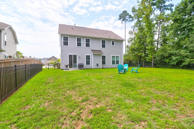 back of house featuring a lawn