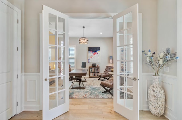 366 Tupelo Lake Dr, Summerville, SC 29486 - entryway with french doors, a wainscoted wall, light wood-style flooring, and a decorative wall