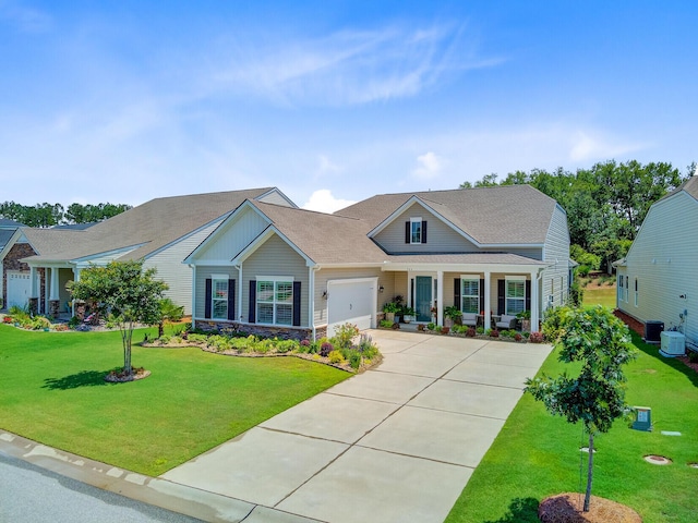366 Tupelo Lake Dr, Summerville, SC 29486 - view of front of home featuring an attached garage, driveway, a front yard, central air condition unit, and stone siding