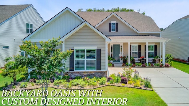 366 Tupelo Lake Dr, Summerville, SC 29486 - view of front of property featuring board and batten siding, a porch, stone siding, and a front lawn