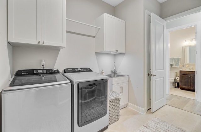 366 Tupelo Lake Dr, Summerville, SC 29486 - laundry area with independent washer and dryer, cabinet space, baseboards, and light tile patterned floors