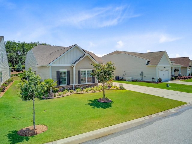 366 Tupelo Lake Dr, Summerville, SC 29486 - view of front of house with an attached garage, stone siding, a front yard, and concrete driveway