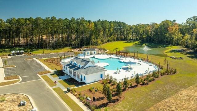 view of swimming pool with a lawn, a patio area, and an outbuilding