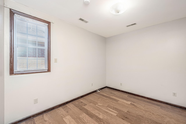 spare room with light hardwood / wood-style floors