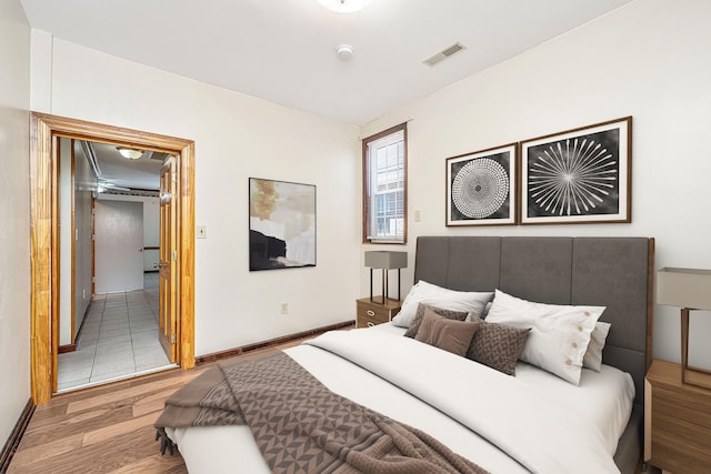 bedroom with hardwood / wood-style flooring