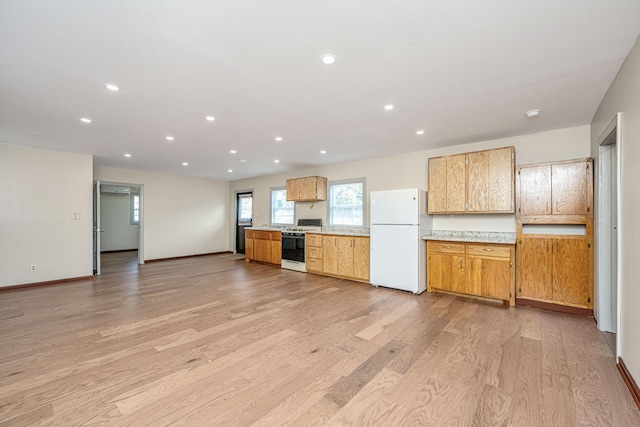 kitchen with light hardwood / wood-style flooring and white appliances