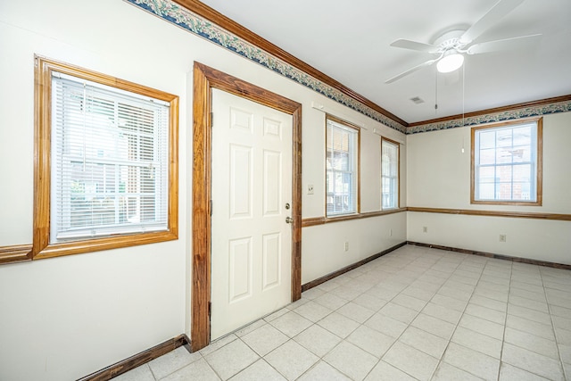 foyer featuring ceiling fan, crown molding, and light tile patterned floors