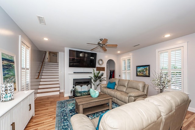 living room featuring ceiling fan and light hardwood / wood-style floors