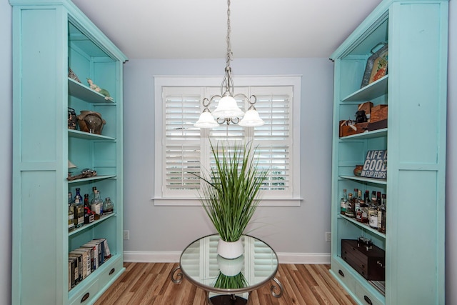 sitting room featuring a chandelier and light hardwood / wood-style flooring