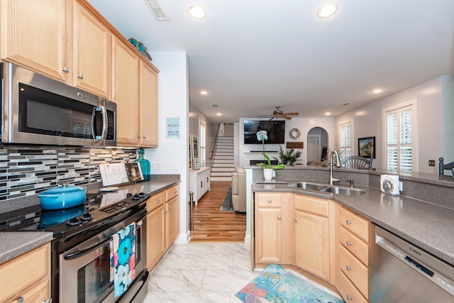 kitchen featuring ceiling fan, sink, light brown cabinets, stainless steel appliances, and light hardwood / wood-style floors