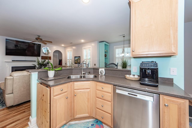 kitchen featuring kitchen peninsula, stainless steel dishwasher, sink, light brown cabinets, and light hardwood / wood-style floors