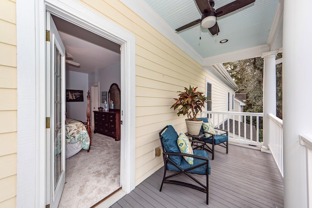 deck with a porch and ceiling fan