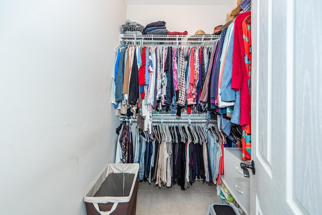 walk in closet with tile patterned floors